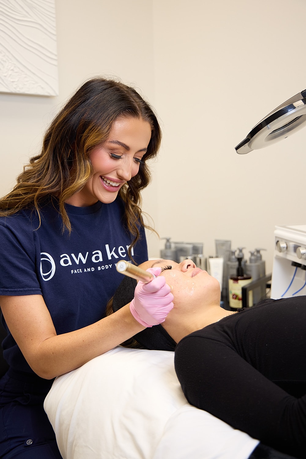 An Awaken aesthetic provider performing a facial treatment.