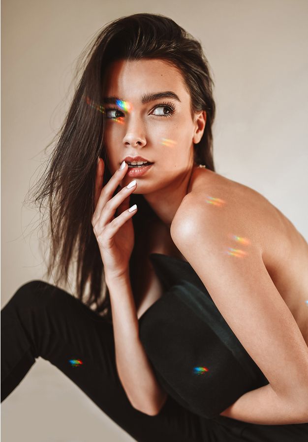med spa patient model posing with playful light reflections.