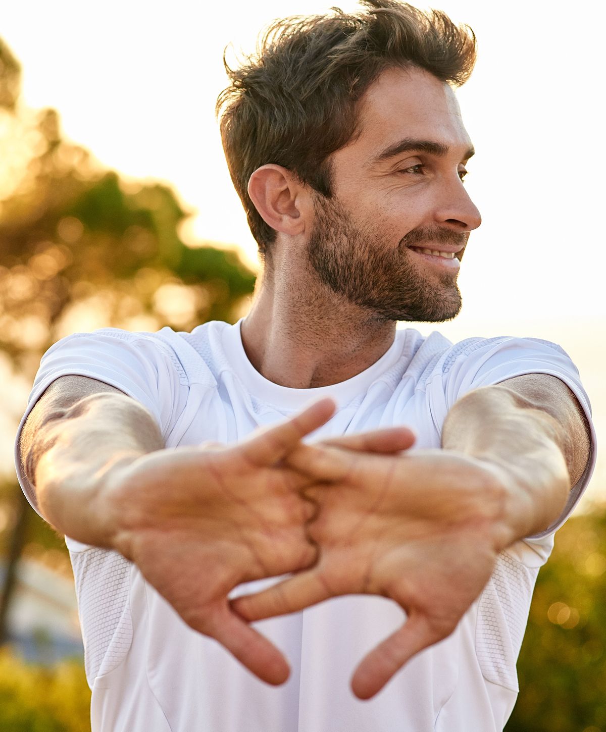 mend health patient model stretching outdoors during sunset.