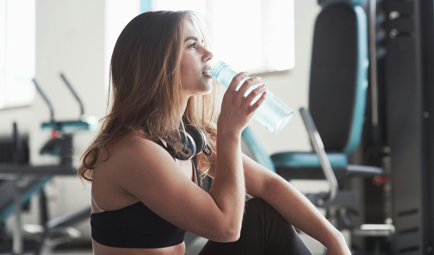 medical weight loss patient model drinking water in a gym setting.